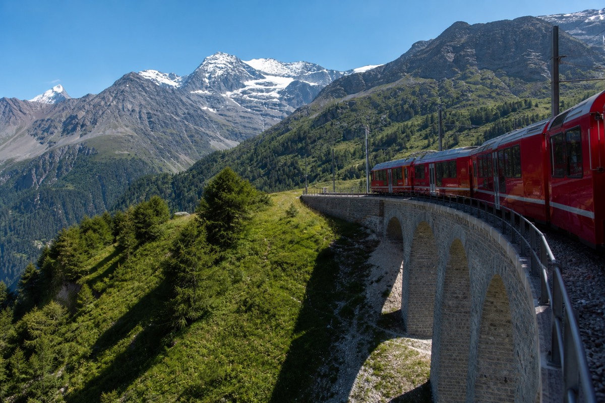 A mountain railway crossing a viaduct in the Swiss Alps
