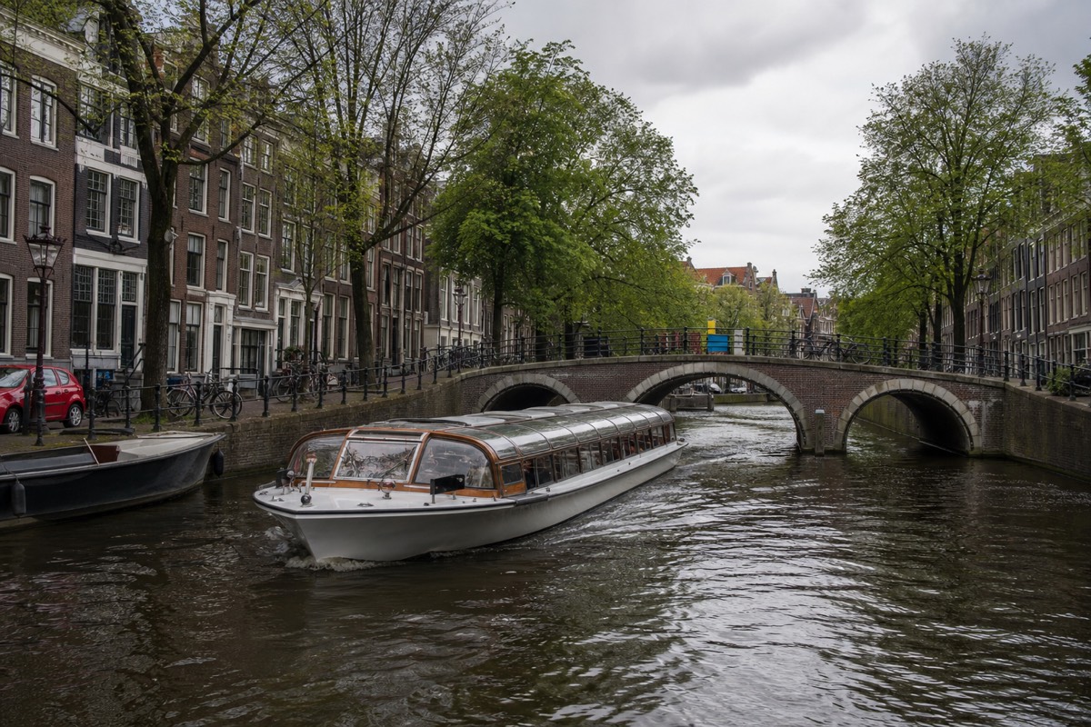 A glass-roofed canal cruise boat in Amsterdam