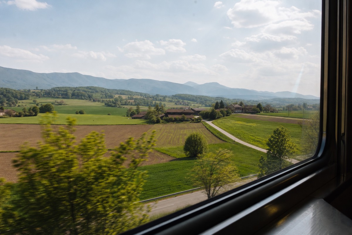 European countryside seen through the window of a moving train